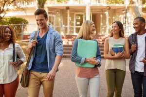 Cropped shot of a group of college students enjoying walking together between classes on campus