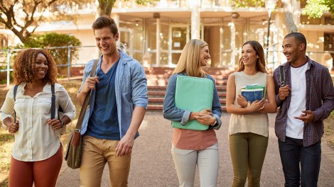 Cropped shot of a group of college students enjoying walking together between classes on campus