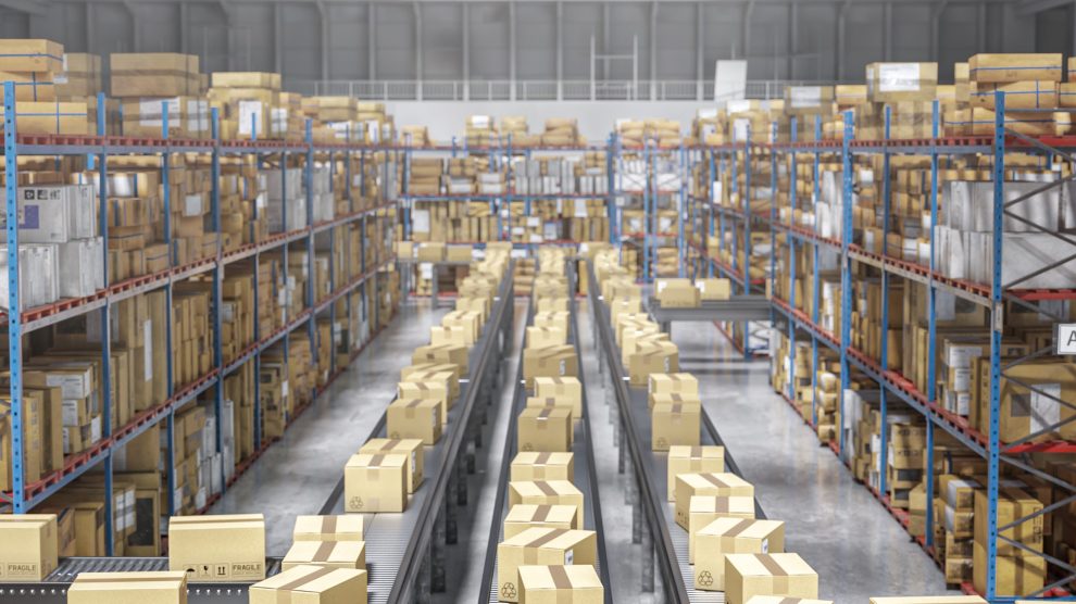 Cardboard boxes moving on conveyor belt in a distribution warehouse