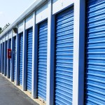 Exterior shot of self storage units with blue doors.
