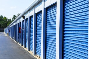 Exterior shot of self storage units with blue doors.
