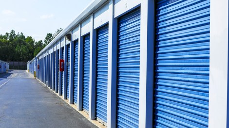 Exterior shot of self storage units with blue doors.
