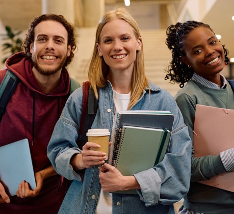 Multiracial group of happy college friends looking at camera.