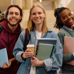 Multiracial group of happy college friends looking at camera.