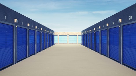 Self storage facility hallway with blue door units.