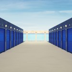 Self storage facility hallway with blue door units.