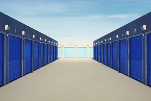 Self storage facility hallway with blue door units.