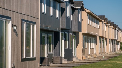 Exterior shot depicting a row of townhomes.