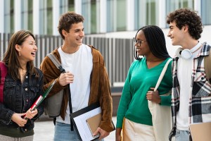 Happy university student friends together in the College campus. Diversity in global education