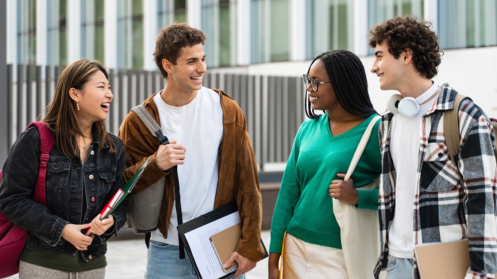 Happy university student friends together in the College campus. Diversity in global education
